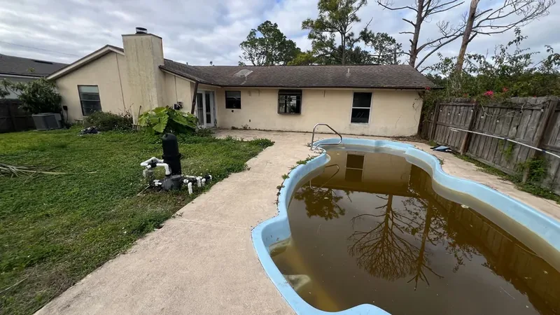 Cluttered backyard before, house sold to us as-is