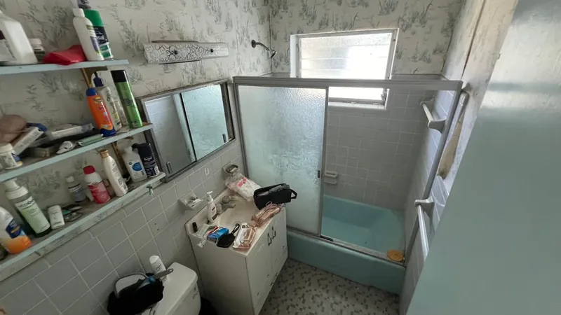 Cluttered bathroom before