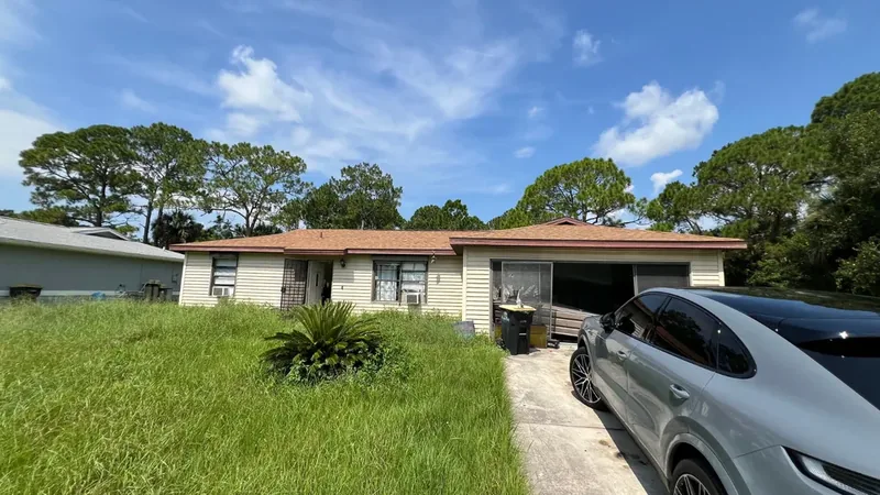 Overgrown house exterior before