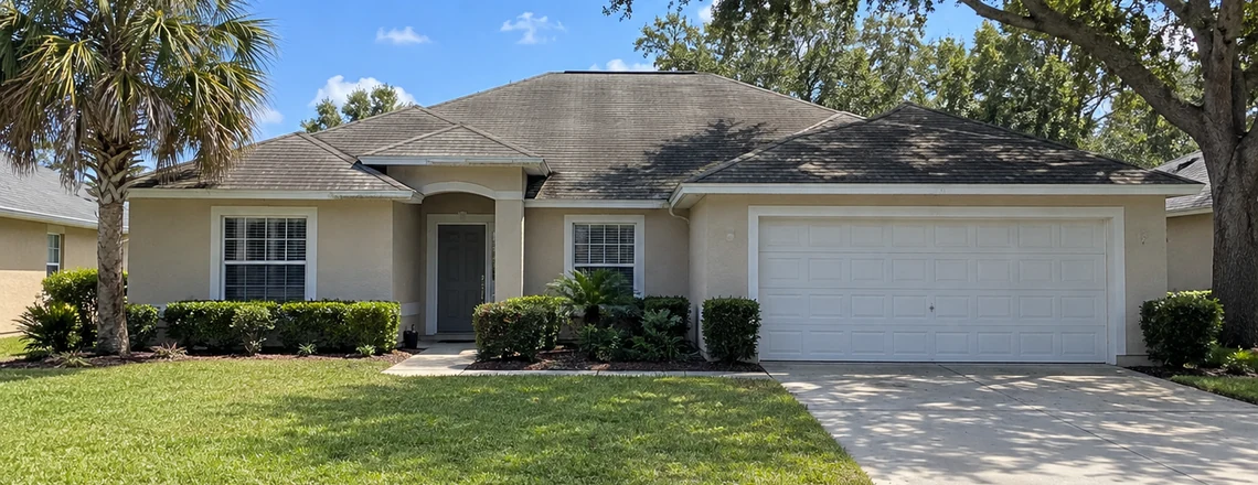 A modest single-story Florida house with a worn shingle roof, a palm and a live oak in the yard, the kind of house sold every week around Tampa