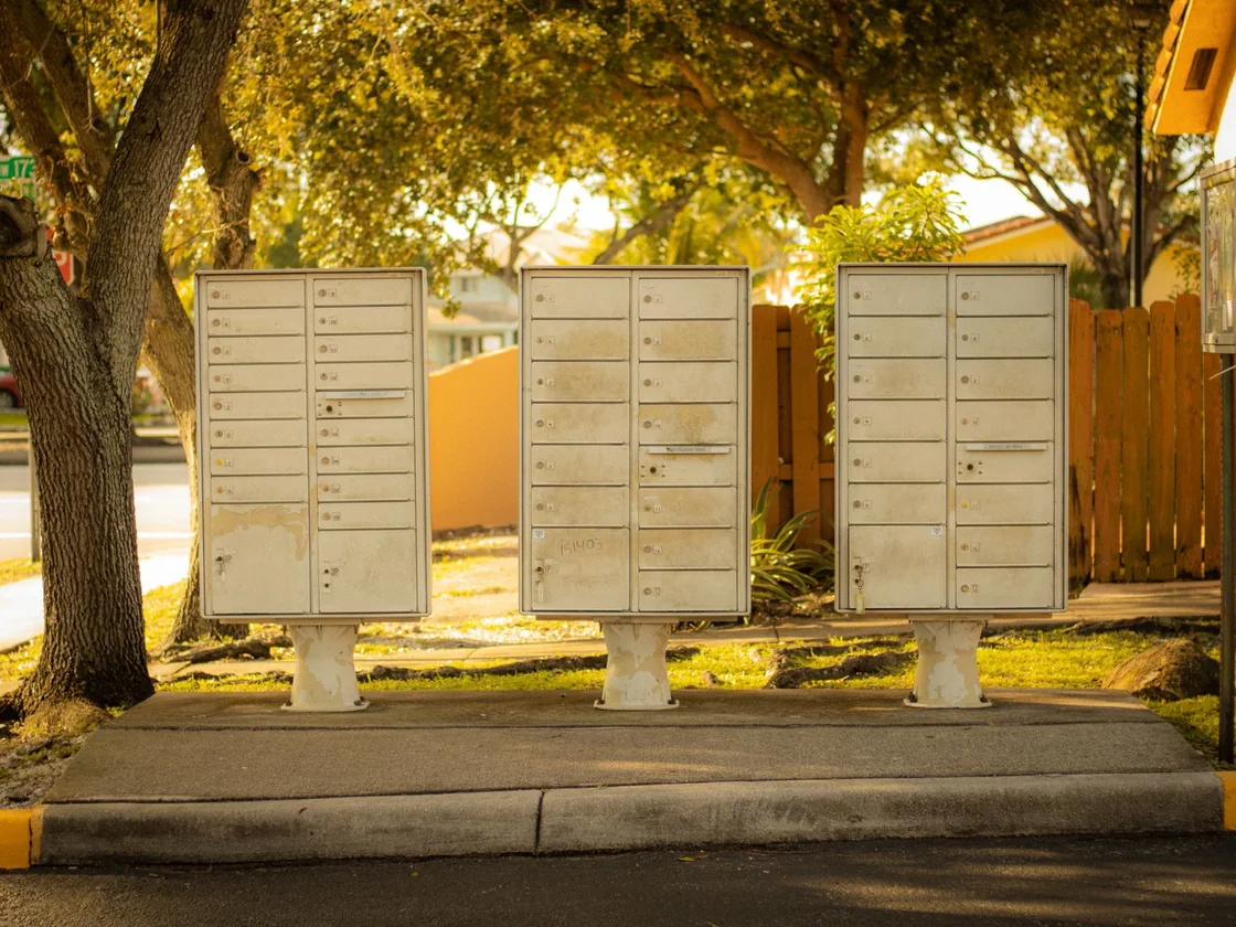 A row of residential mailboxes on a quiet street where a notice letter would arrive