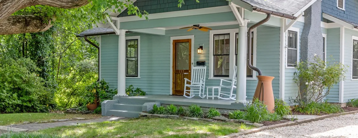 A modest American single-family home being sold while a lien sits on the title
