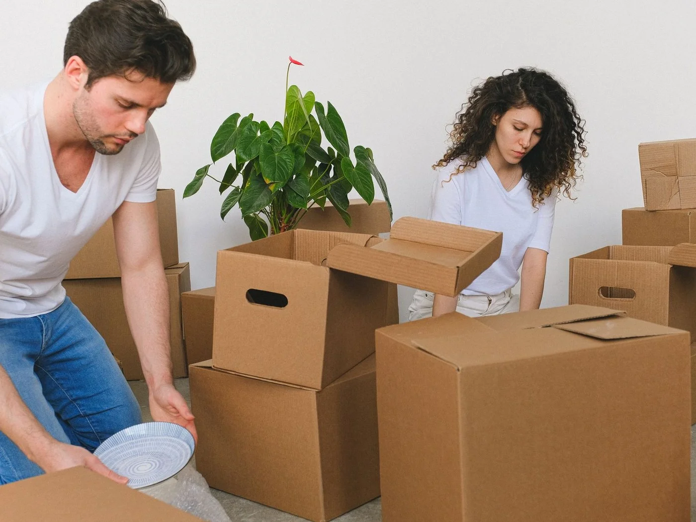 Couple packing moving boxes before a move