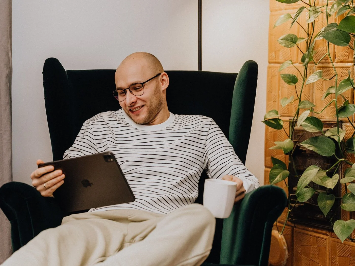 Man relaxing in an armchair with a coffee, done with landlord duties