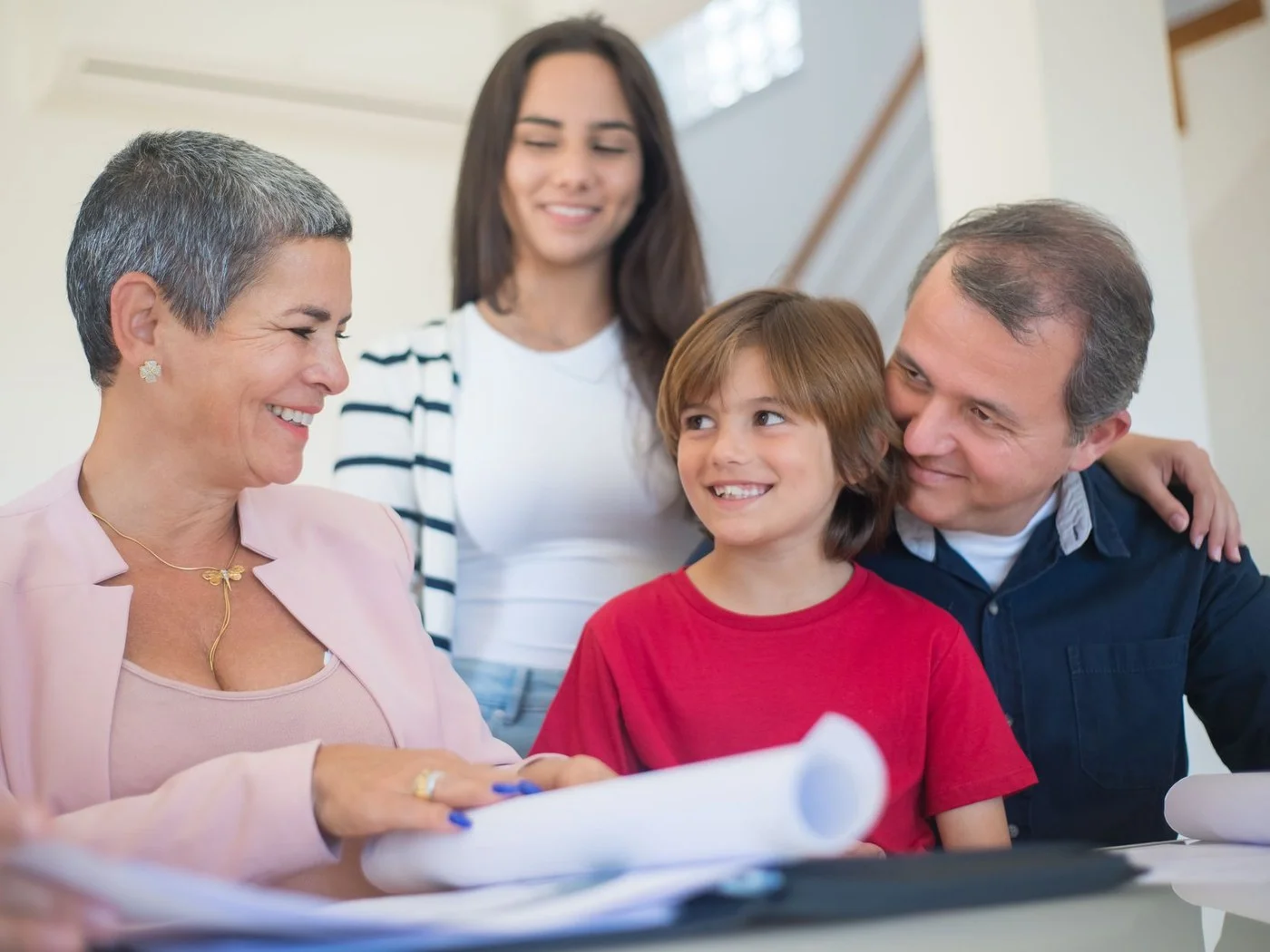 Family smiling while signing closing documents